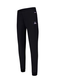Svarta sweatpants i mjukt tyg, med slim fit, elastisk midja och ribbade muddar. Inkluderar en logotyp på vänster lår.
