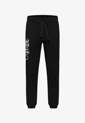 Black sweatpants made of soft fabric, featuring a drawstring waistband and graphic text on one side. Elastic cuffs at the ankles.
