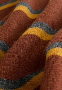 Wool blend fabric in warm rust, mustard yellow, and dark gray. Features soft texture with wavy striped pattern throughout.