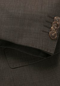 Brown textured fabric with a smooth finish, featuring four brown buttons on the cuff and subtle pinstripes. Tailored cut detail visible.