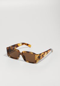 Tortoiseshell sunglasses with brown tinted lenses, rectangular frames, and smooth texture. Features subtle branding on the temple.