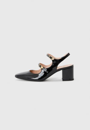 Black patent leather slingback shoe with a pointed toe, two strap closures, and a chunky heel. Smooth texture and minimalistic design.