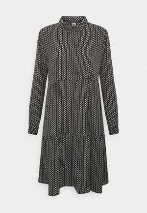 Musta pitkähihainen mekko, jossa pieniä valkoisia lehtikuvioita, korkea pääntie, kerätty vyötärö ja kerroksittain levenevä helma.