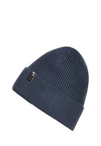 Bonnet en tricot bleu marine avec une texture côtelée, doté d'un revers et d'une petite étiquette noire avec un logo blanc.
