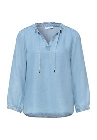 Blouse bleu clair à manches longues avec col en V, col à volants et liens à cordon, en tissu denim doux.