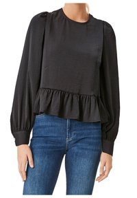 Blusa nera a maniche lunghe con scollatura rotonda, spalle arricciate e orlo a peplo. Realizzata in tessuto leggero con una texture liscia.