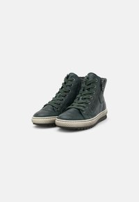 Green leather high-top sneakers with laces and side zippers, featuring a textured sole and contrasting cream-colored rubber outsole.