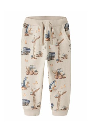 Pantalon beige pour enfants avec taille élastique et cordon, avec des engins de chantier imprimés et des cônes de signalisation orange.