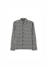 Chemise à carreaux noir et blanc en tissu doux, avec un col classique, des manches longues et une fermeture à boutons à l'avant.