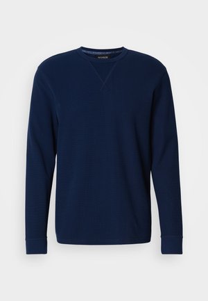 Felpa blu navy a maniche lunghe con scollo a girocollo, polsini a costine, tessuto morbido e dettaglio a punto croce sullo scollo.