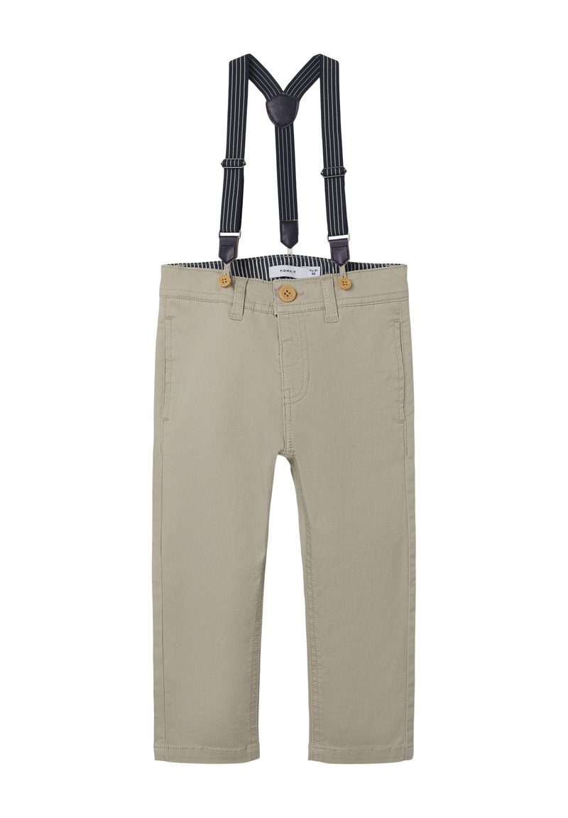 Pantaloni beige con bretelle regolabili a righe blu e bianche. Presentano due tasche frontali e due bottoni sulla vita.