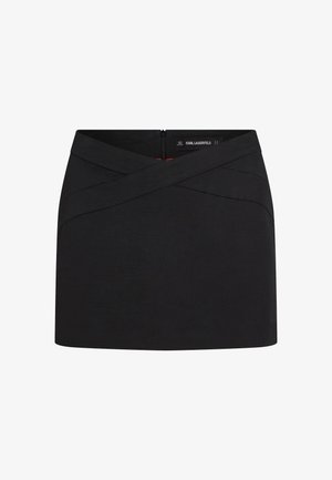 Svart miniskjørt med omslagsmidjebånd og synlig glidelås bak, merket Karl Lagerfeld, enkel og skreddersydd stil.
