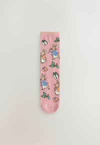 Pink socks featuring illustrated rabbits in clothing, holly leaves, and gifts. Soft texture with a ribbed top in a contrasting color.