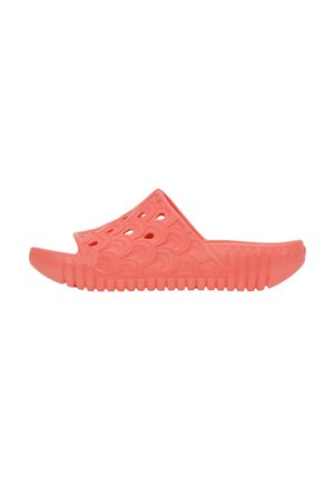 Coral slide sandal made of rubber with a textured wave pattern and open toe design. Features a ridged sole for grip and comfort.