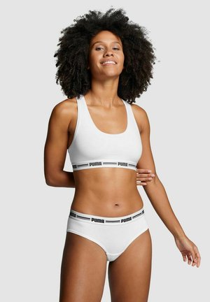 White sports bra and matching briefs with black "PUMA" logo on the bands. Smooth fabric with a fitted design and a scoop neckline.