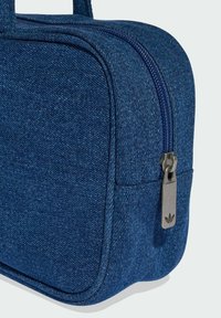 Denim carry bag in dark blue with a zip closure and metal pull tab. Features smooth texture and rounded corners, suitable for small items.