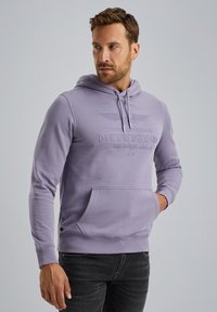 Lilac hooded sweatshirt with a front pocket and embossed text. Features a drawstring hood and ribbed cuffs. Made of soft fabric.