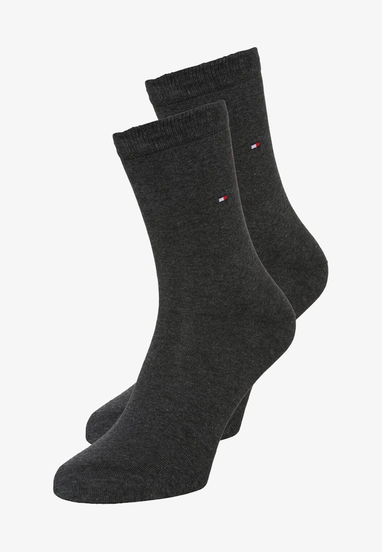 Charcoal gray cotton socks with ribbed cuffs and a small embroidered logo in red, white, and blue near the top. Smooth texture.