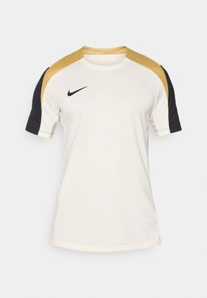Hvid sportstrøje med sorte ærmer og gyldne detaljer. Har en rund hals, korte ærmer og et Nike-logo på venstre bryst.