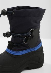 Black rubber boot with a navy fabric upper, blue accents, and drawstring closure. Features reinforced heel and textured stem for grip.