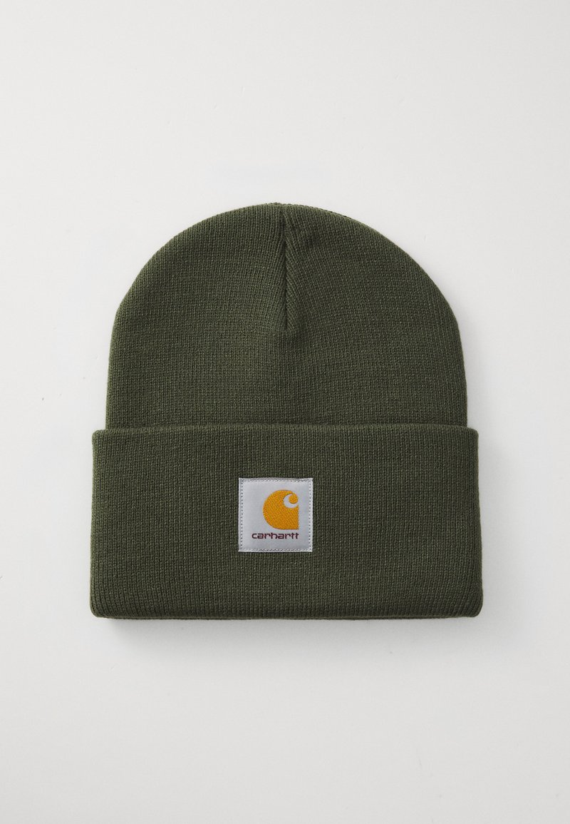 Green knitted beanie hat with a cuff. Features a square white patch displaying a yellow logo and brand name "Carhartt" in black lettering.
