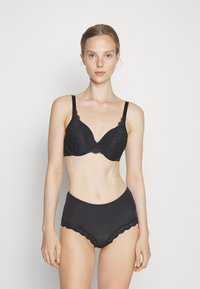 Black lace plunge bra with underwire, scalloped edges, and thin straps. High-waisted black underwear with lace trim and smooth texture.
