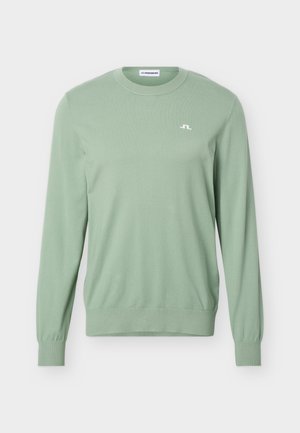 Světlé zelené svetřík s dlouhým rukávem a kulatým výstřihem, s žebrovanými manžetami a malým bílým logem J.Lindeberg na levé hrudi.