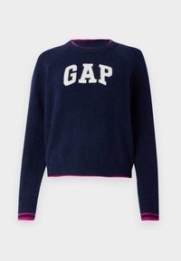 Pulover tricotat de culoare marină cu logo-ul "GAP" în alb. Guler și tiv cu nervuri, evidențiate de dungi roz. Mâneci lungi, design scurt. Textură moale.