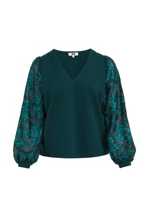 Blouse vert foncé avec col en V et manches longues bouffantes transparentes décorées de sequins floraux.