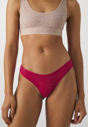 Lys beige blonde bh med et bredt merke bånd, kombinert med en livlig rosa blonde tang med blomster mønster og tynne kanter.