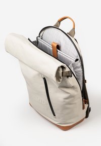Roll-top backpack in light beige, with black zipper, tan accents, and gray interior pockets. Textured fabric with sturdy handles and straps.