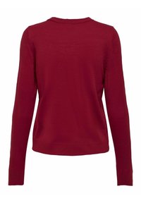 Pull rouge avec un col rond, des manches longues et une texture en tricot douce. L'ourlet et les poignets sont côtelés pour un ajustement serré.