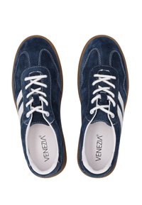 Blue suede sneakers with white stripes, round toe, white laces, and rubber sole. Interior features branding label and soft lining.