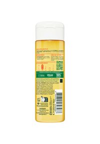 Bottiglia di plastica gialla con tappo flip-top bianco. L'etichetta presenta del testo in italiano, un codice QR e icone che indicano informazioni vegetali e di riciclo.