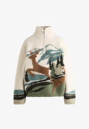 Bluza polarowa w kremowym kolorze z półzamkiem. Posiada teksturowany wzór przedstawiający skaczącego jelenia, góry i drzewa w odcieniach zieleni i brązu.