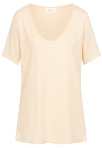 Kratký rukáv, tričko s výstřihem do V z lehké béžové bavlny. Jednoduchý design s hladkou texturou a bez viditelných vzorů nebo akcentů.