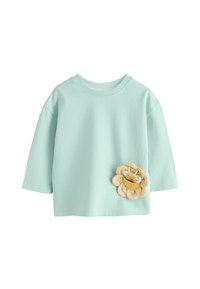 Camiseta de algodón azul claro con cuello redondo y mangas tres cuartos, con un diseño de flor 3D y un pequeño detalle de abeja.