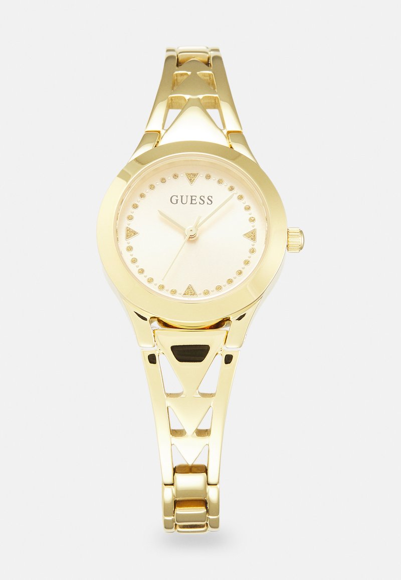 Montre en or avec un boîtier rond, un cadran crème et des index horaires triangulaires. Présente un bracelet à découpes géométriques avec une finition polie.