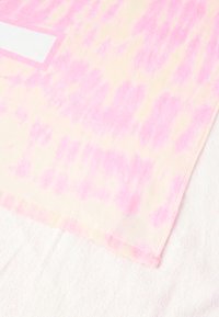 Ľahký šál z mäkkého materiálu s prechodovým vzorom v ružových a krémových odtieňoch. Okraje sú zdobené jemnou lemovkou.