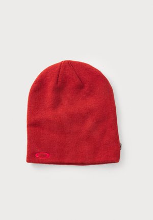 Red knit beanie with a snug fit, featuring a rounded top and a small pink logo patch on the side. Soft texture, ideal for cold weather.