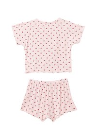 Ensemble de pyjama rose à manches courtes avec un motif à pois. Le haut présente un ourlet arrondi; le short a une taille élastique et des bords festonnés.