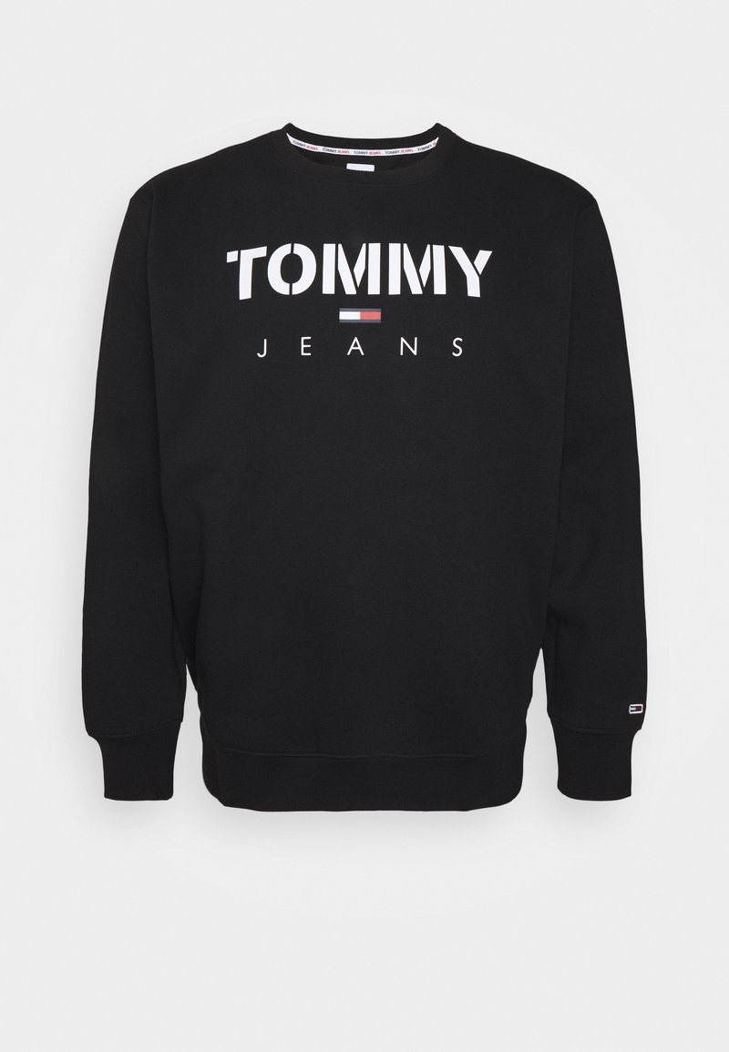 Felpa nera in cotone. Presenta "TOMMY JEANS" in grandi lettere bianche e un piccolo emblema a forma di bandiera. Collo rotondo con polsini a costine.