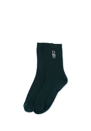 Paire de chaussettes montantes noires côtelées avec logo brodé blanc "D2M" près du haut du bord sur une chaussette.