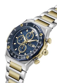 Ceas cronograf cu un cadran albastru cu model, accente aurii, brățară din oțel inoxidabil argintiu și ton de aur, și scală tachimetrică.