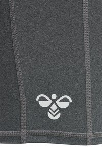 Grå atletisk tyg med en jämn textur och synliga sömmar, med en vit bi-logotyp längst ner.