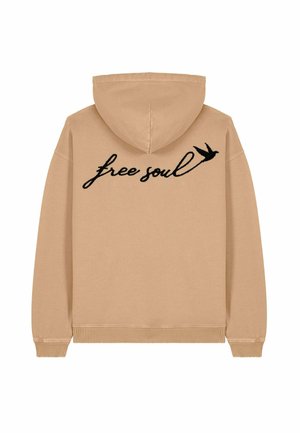 Felpa beige con cappuccio regolabile e polsini a coste. "Anima libera" in testo corsivo nero con una grafica di un uccello stampata sul retro.
