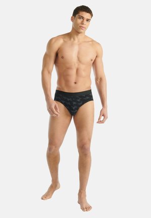 Slip da bagno neri con motivo geometrico testurizzato, caratterizzati da una fascia in vita nera solida e una vestibilità aderente e aerodinamica.