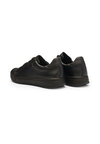 Black leather sneakers featuring a textured finish, rounded shape, rubber outsole, and lace-up design. Subtle stitching accents on sides.