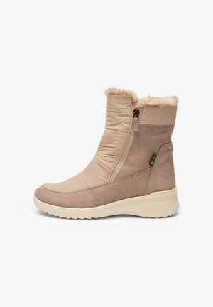 Beige ankle boot featuring a quilted textile upper, faux fur trim, and side zipper. Suede accents and textured rubber sole for grip.
