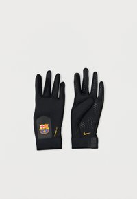 Fekete sportkesztyű, textúrált tapadással, ergonomikus formával és a tenyéren elhelyezett Barcelona logóval. Nike márkajelzés a csuklón.